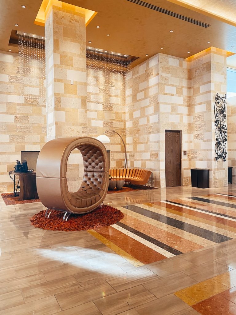 brown wooden round table near brown brick wall